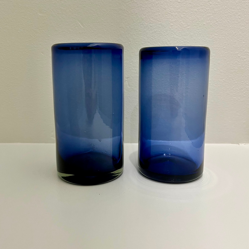 Studio CM | A tall highball glass with a deep blue color that was handblown in jalisco, mexico from recycled