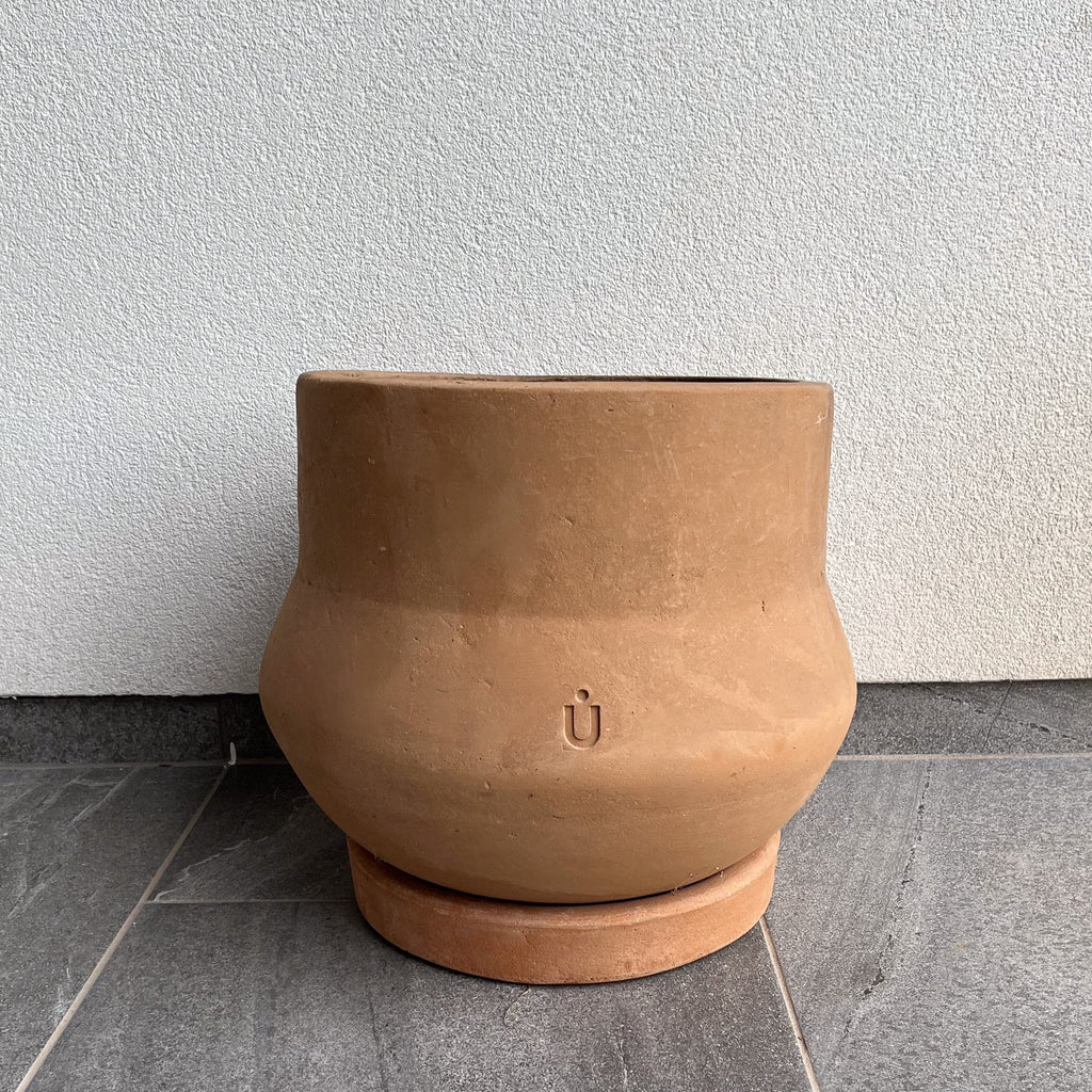 Studio CM | a modern 23 pound outdoor ceramic planter with a cylindrical body and round bottom that has a matching base