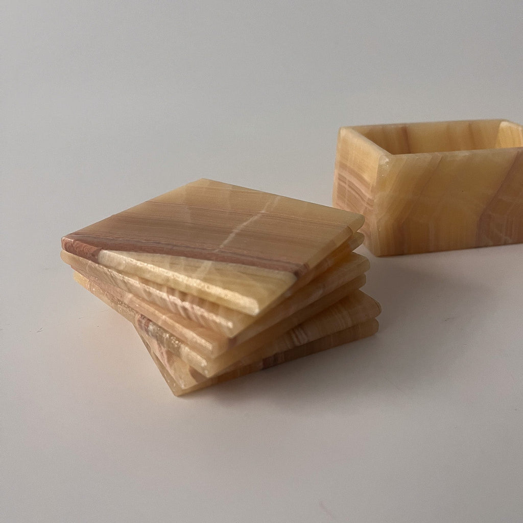 Studio CM | a set of caramel hand carved marble coasters in a square shape