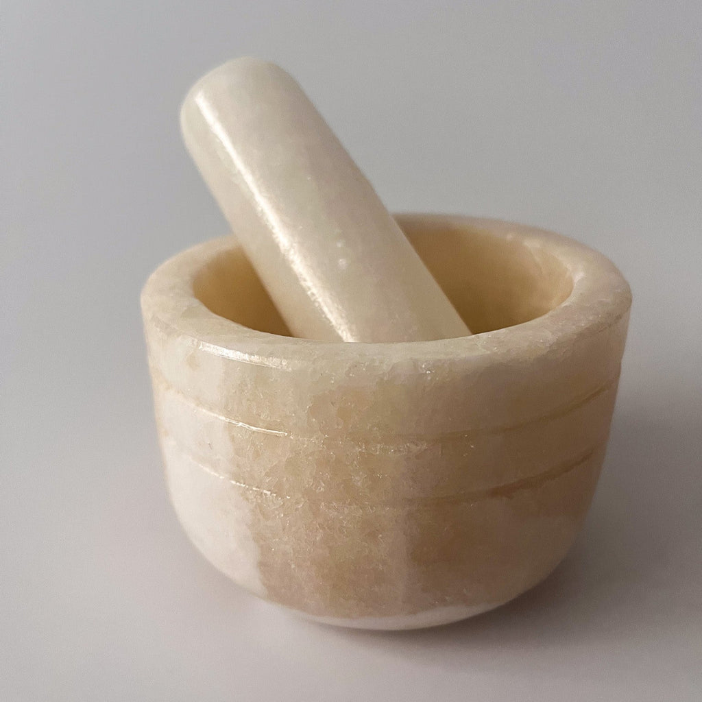 Studio CM | a large mortar and pestle made of white onyx