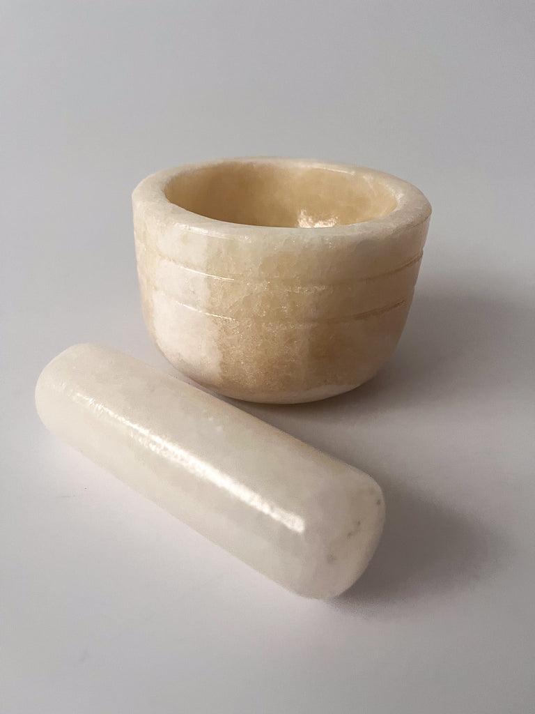 Studio CM | a large mortar and pestle made of white onyx