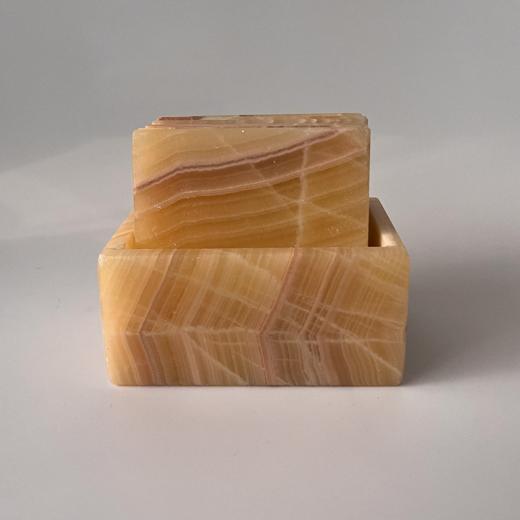 Studio CM | a set of caramel hand carved marble coasters in a square shape