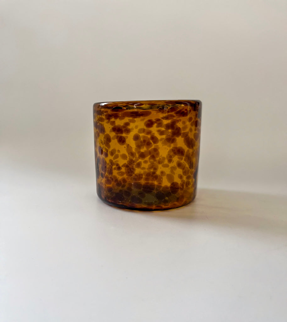 Studio CM | Tortoiseshell patterned glass vase on a white background