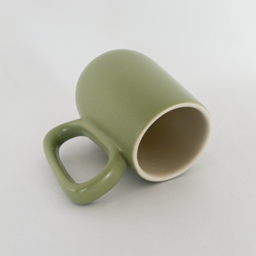 Studio CM | A handmade ceramic mug that has a lovely green color on the outside and white ceramic inside