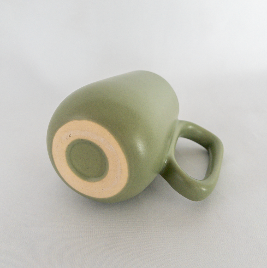 Studio CM | A handmade ceramic mug that has a lovely green color on the outside and white ceramic inside