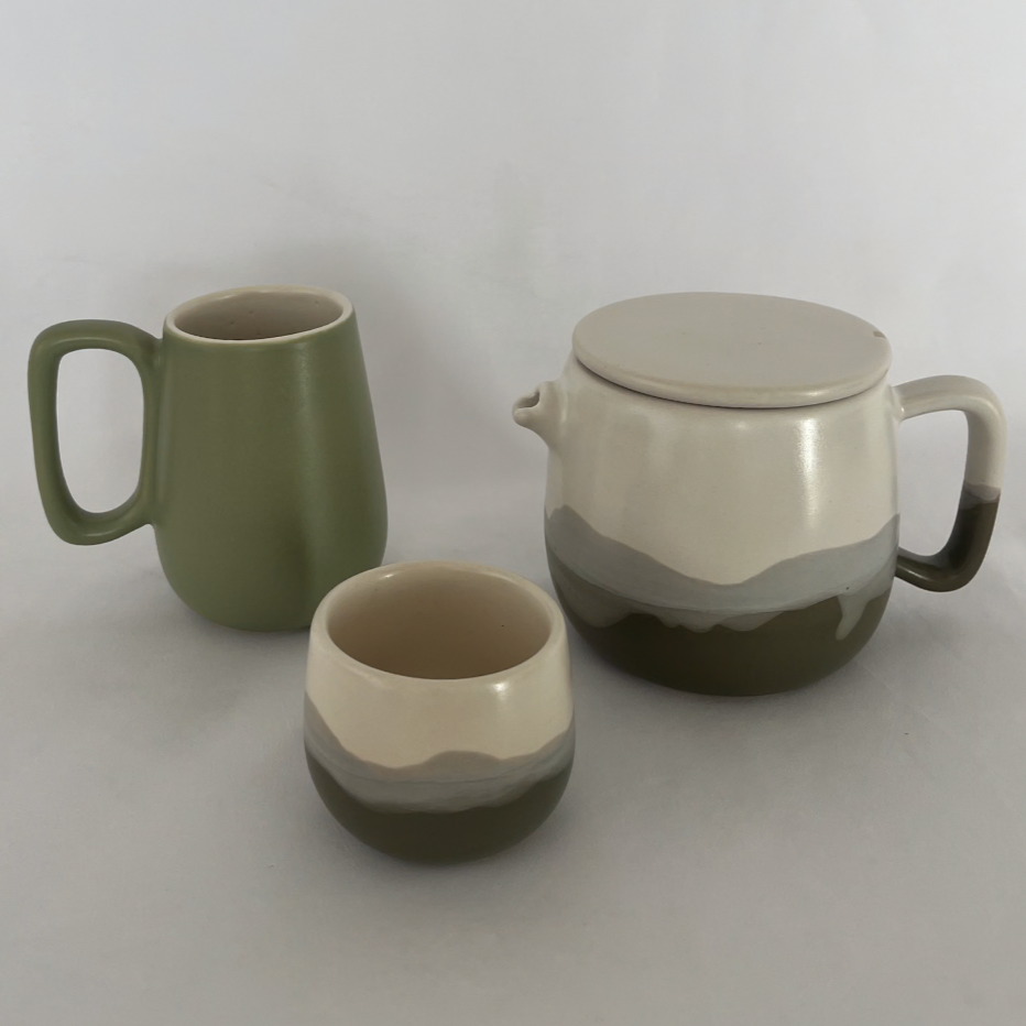 Studio CM | a handmade collection of ceramic drinkware including the green mug, tea cup and tea pot with green wave colors