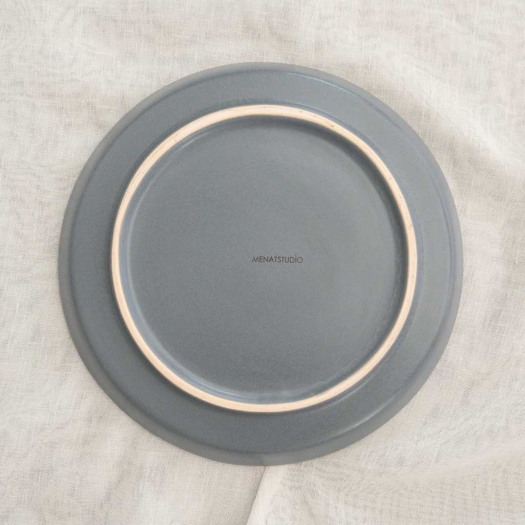 Studio CM | A two tone ceramic plate with a cream speckled surface and light blue base