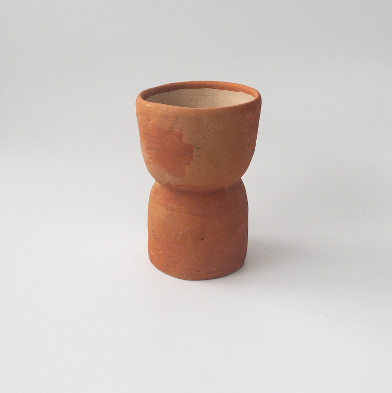 Studio CM | A terracotta colored ceramic planter that is handmade in Oaxaca with an hourglass shape with a drainage hole