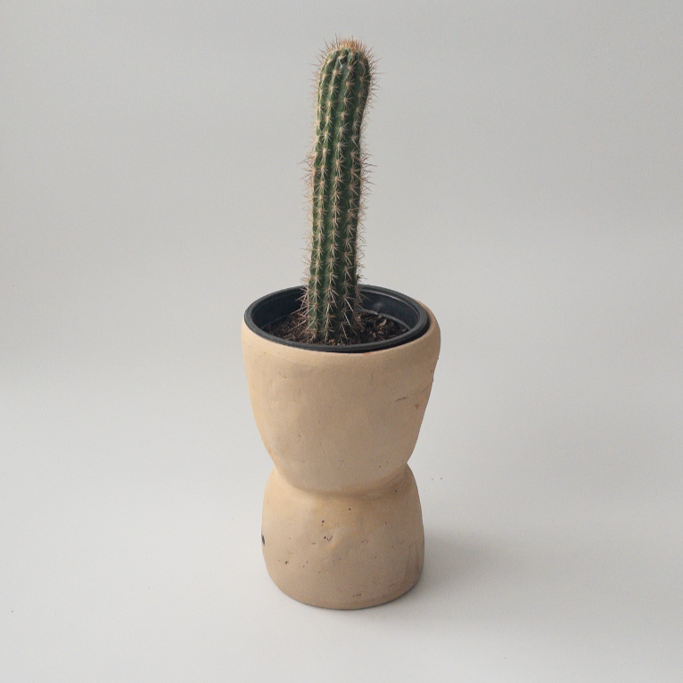 Studio CM | A beige colored ceramic planter that is handmade in Oaxaca with an hourglass shape with a drainage hole