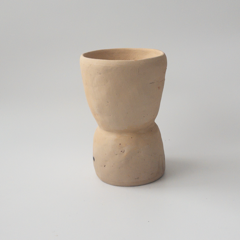 Studio CM | A beige colored ceramic planter that is handmade in Oaxaca with an hourglass shape with a drainage hole