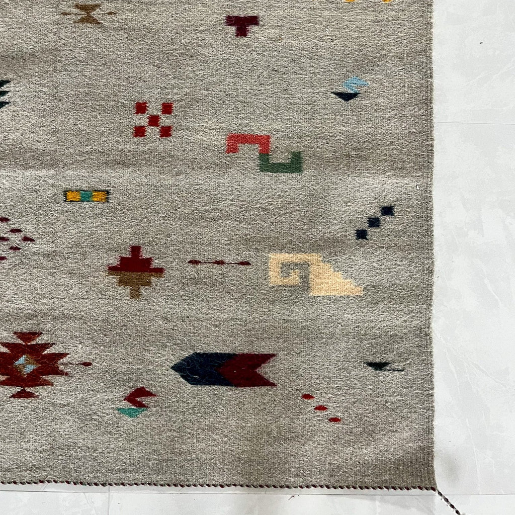 Studio CM | A cream rug with traditional Zapotec shapes that are multicolor handwoven wool from Oaxaca Mexico