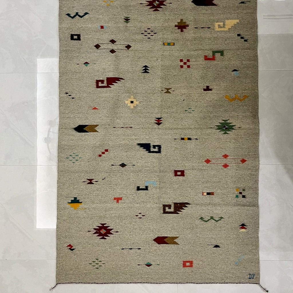 Studio CM | A cream rug with traditional Zapotec shapes that are multicolor handwoven wool from Oaxaca Mexico