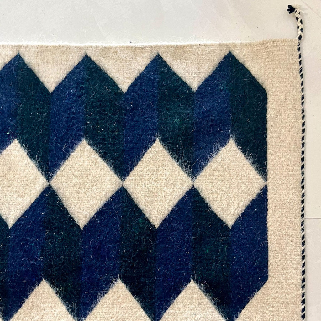 Studio CM | A wool handwoven rug from Oaxaca that was made with natural dyes and materials with a blue, navy and cream geometric pattern