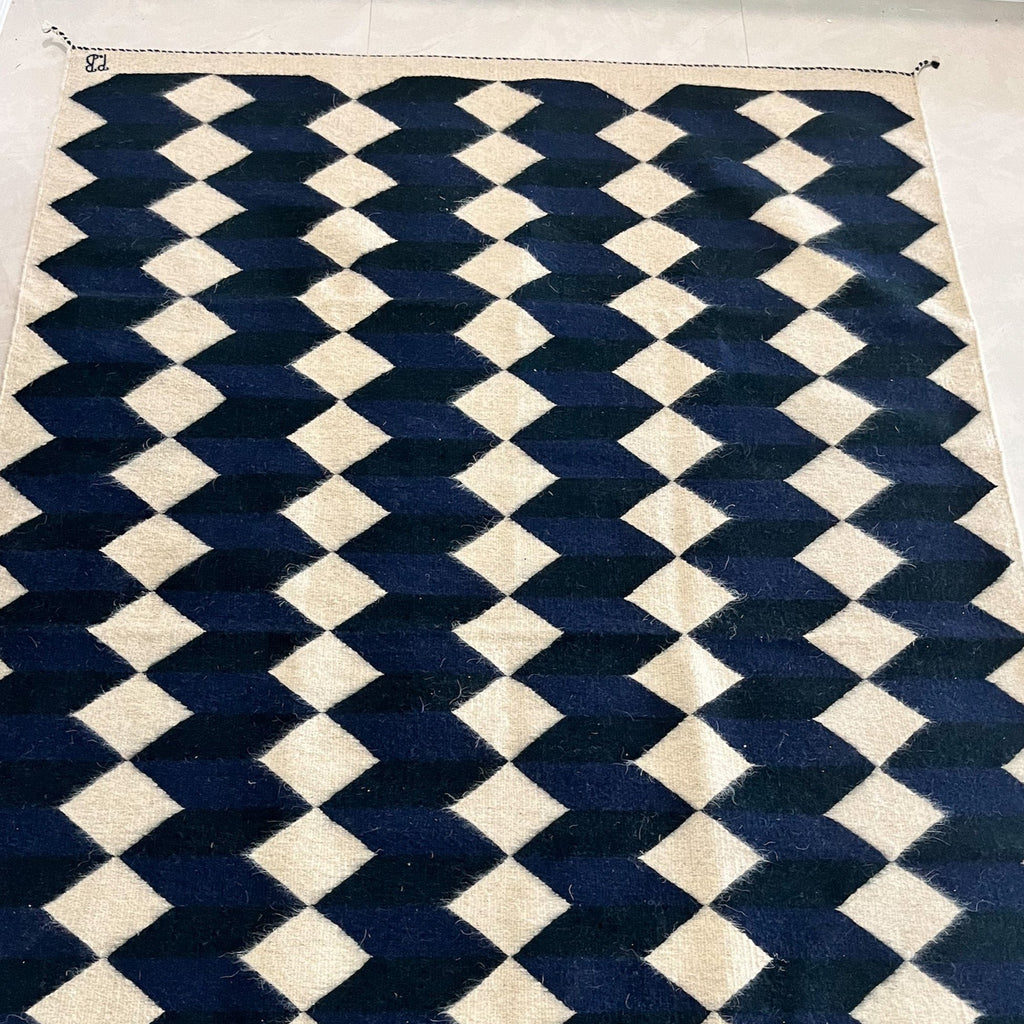 Studio CM | A wool handwoven rug from Oaxaca that was made with natural dyes and materials with a blue, navy and cream geometric pattern