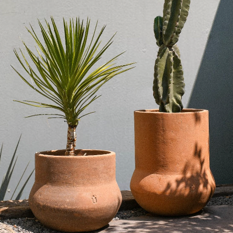 Studio CM | a modern 23 pound outdoor ceramic planter with a cylindrical body and round bottom that has a matching base