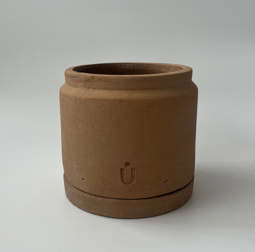 Studio CM | A cylindrical and modern planter made of terracotta that comes with it's matching dish