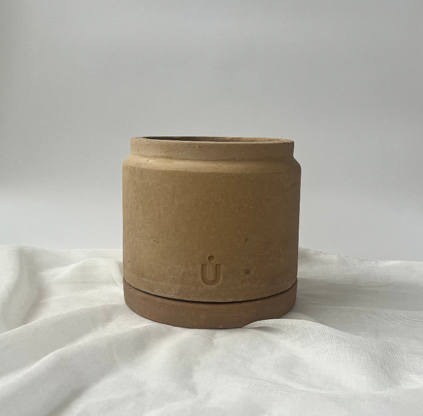 Studio CM | A short cylindrical and modern planter made of terracotta that comes with it's matching dish