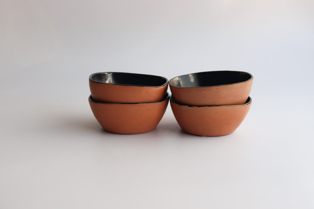 Studio CM | two stacks of four ceramic bowls with a natural clay exterior with a white background