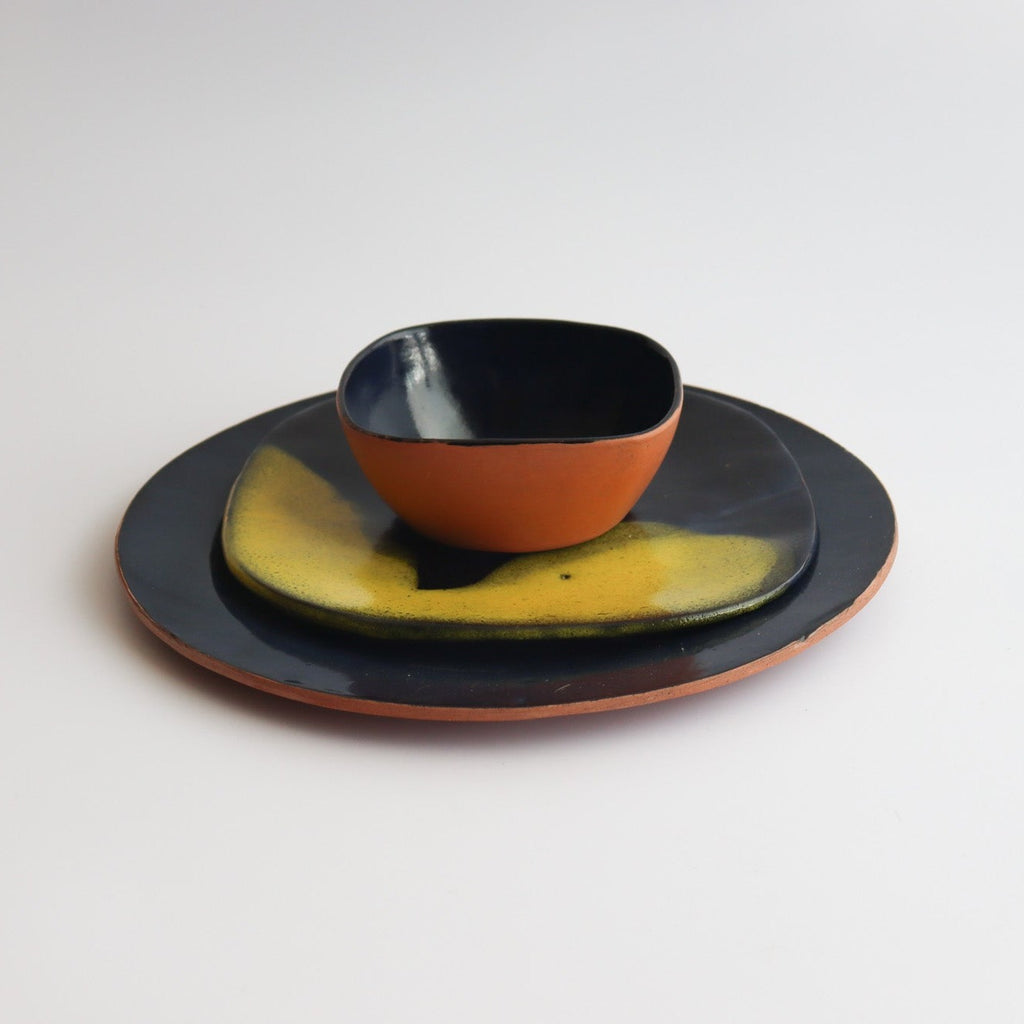 a set of bowl and two plates of ceramic handmade table set