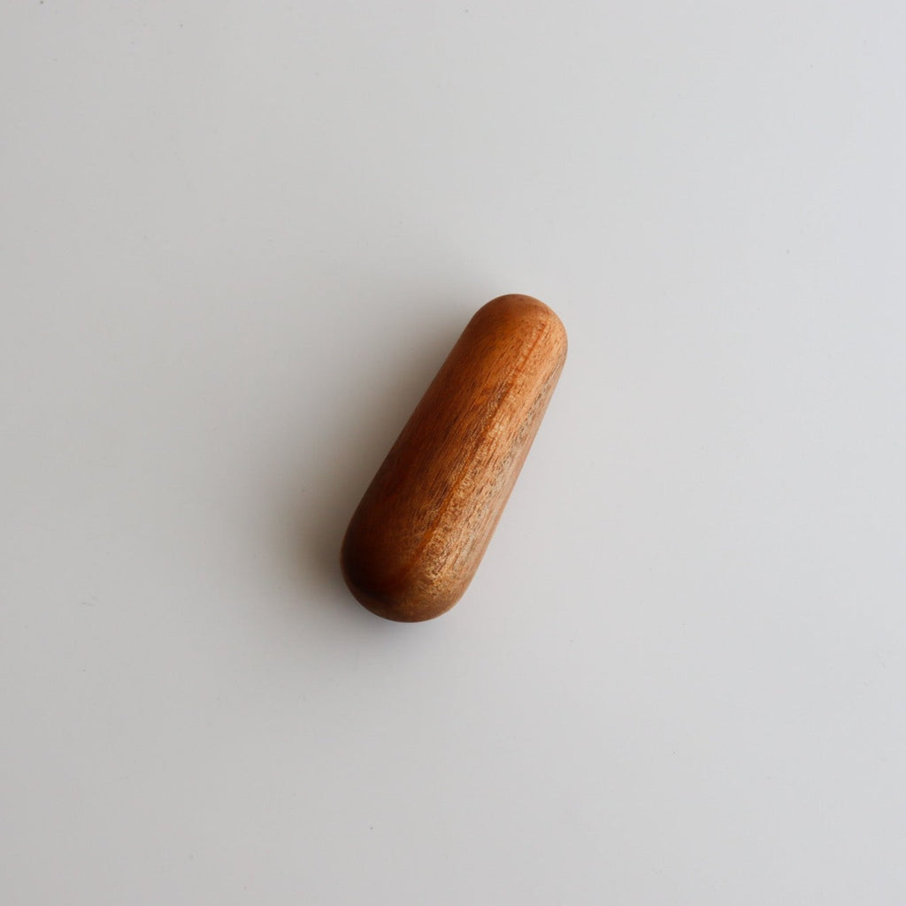 Studio CM | a small handcrafted wooden pestle on a white background