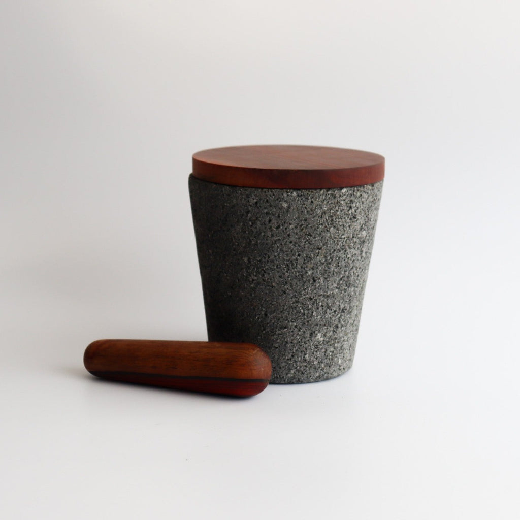 Studio CM | extra large volcanic stone mortar with a wooden top including a wooden pestle with a white background