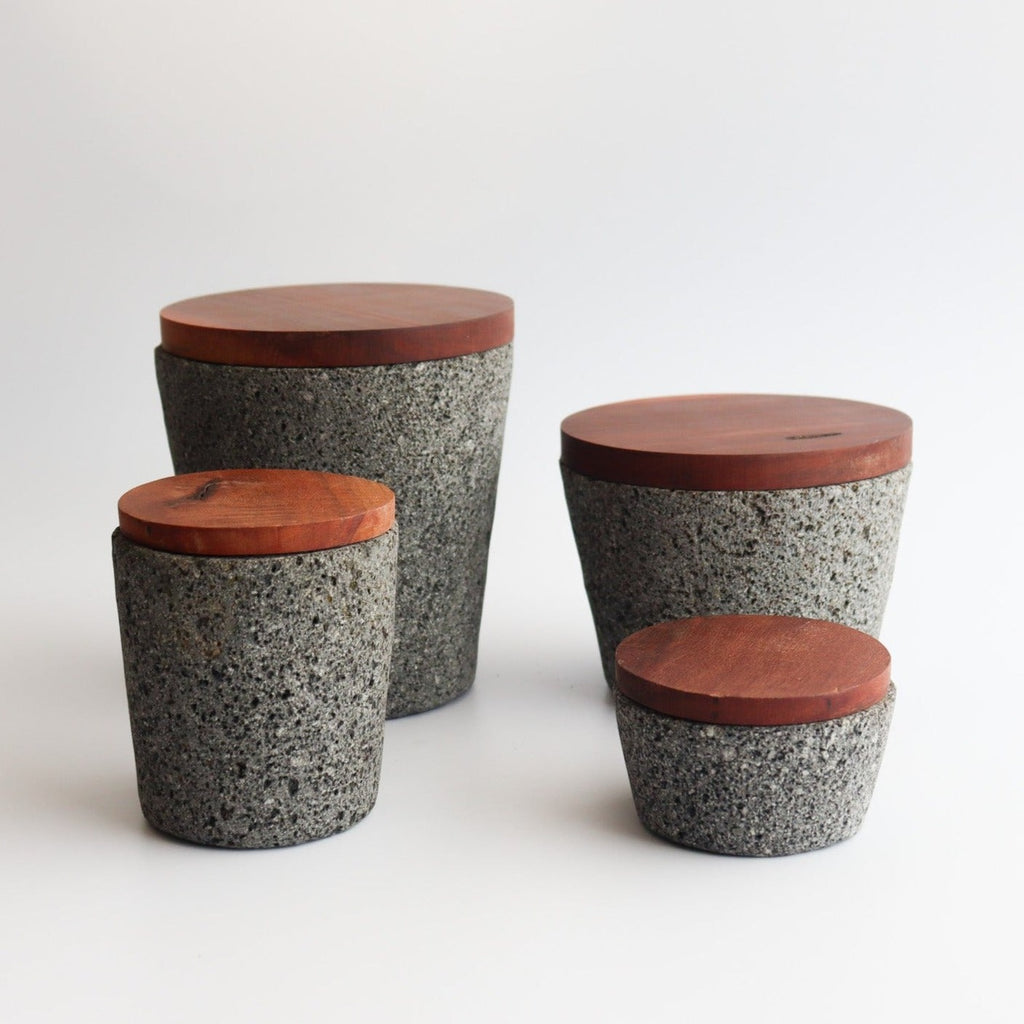 Studio CM | medium volcanic stone pestle with a wooden top and wooden top on a white background