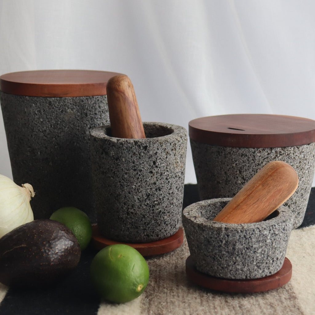 Studio CM | medium volcanic stone pestle with a wooden top and wooden top on a white background