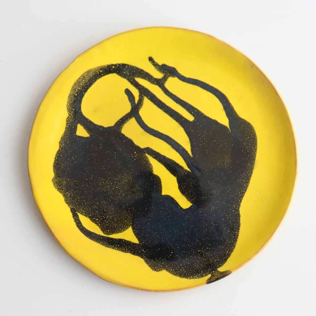 picture of handmade yellow ceramic plate with blue abstract painting