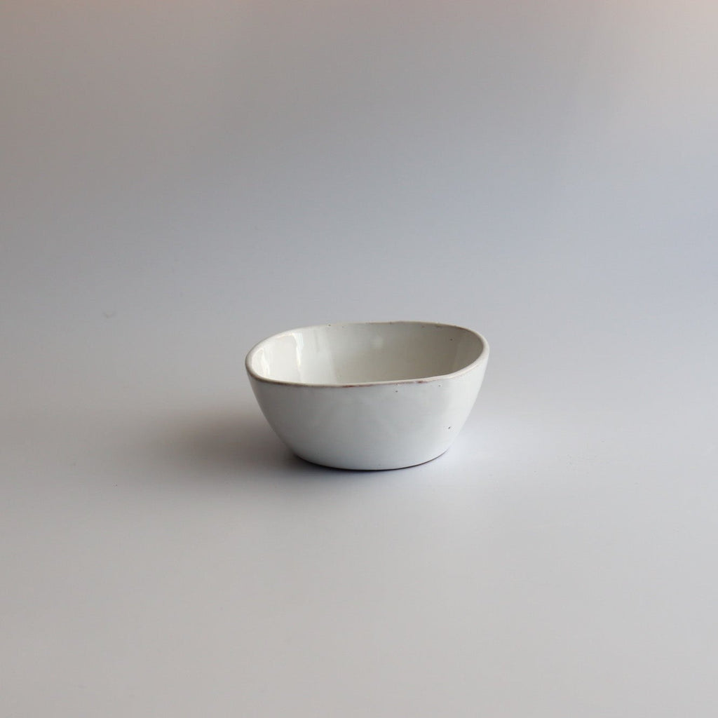 a beautiful white handmade ceramic plate with white glaze on a white background