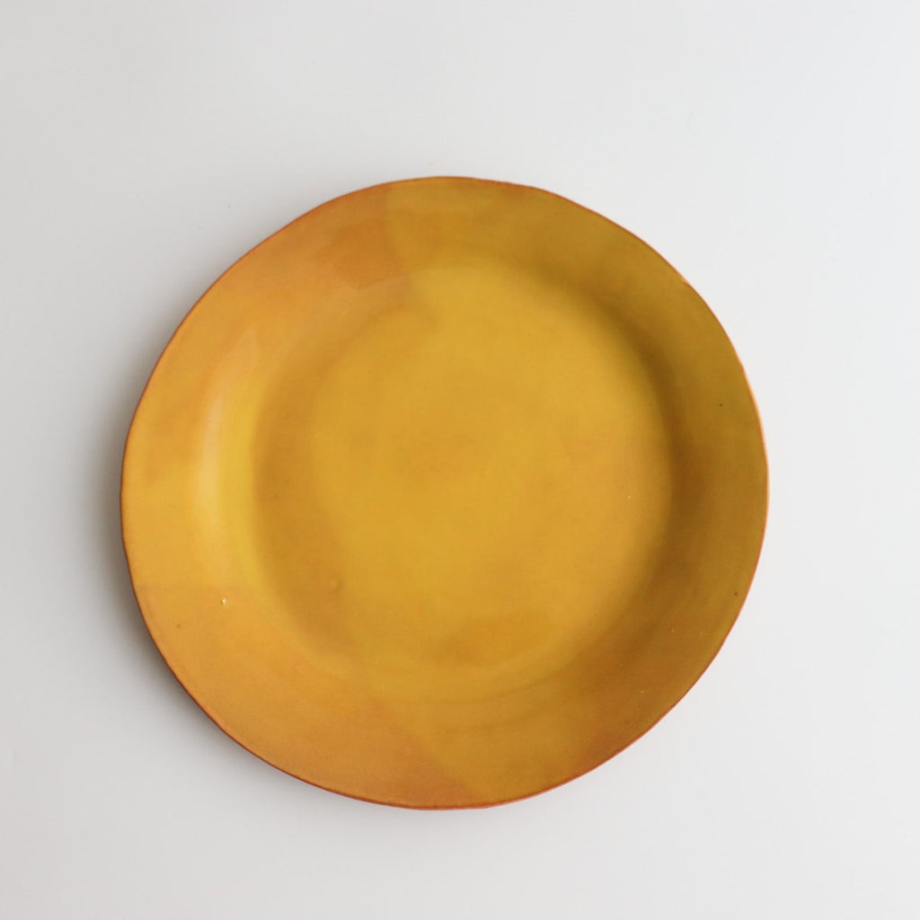 large yellow ceramic plate on a white background