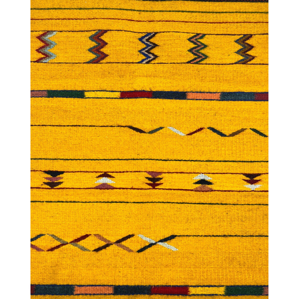 Studio CM | yellow zapotec rug with fringe ends decorated with vibrant traditional symbols