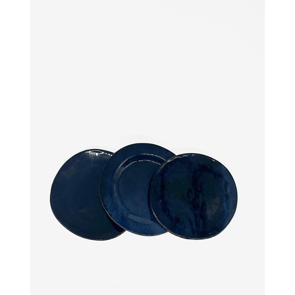 three blue ceramic plates with a white background